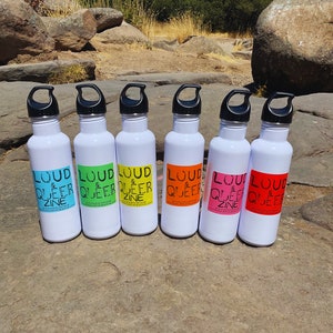 May include: Six white water bottles with black lids and rainbow colored labels that say "Loud & Queer Zine".