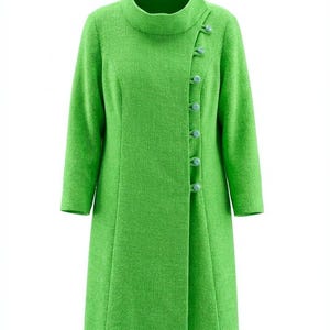 Puede incluir: Un abrigo verde brillante con cuello alto y mangas largas. El abrigo presenta una hilera de botones verde claro y una tela texturizada. El abrigo es de largo medio.