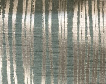 May include: Textured fabric with a teal background and vertical silver stripes. The stripes have a distressed, brushstroke-like appearance, creating a modern, abstract design. The fabric has a subtle sheen.