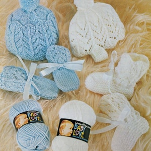 May include: Two skeins of yarn, one blue and one white, labeled "Lister/Lee  Baby Love Double Knitting".  A set of blue knitted baby booties and mittens with a white ribbon. A white knitted baby hat and booties.