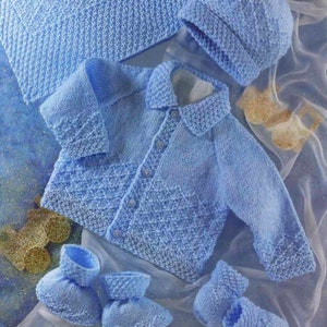 May include: A knitted baby set in light blue, including a cardigan, hat, and booties. The set features a diamond pattern and button fastenings.