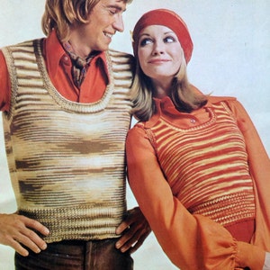 May include: A couple wearing striped knit vests. The man is wearing a red shirt with a brown patterned tie. The woman is wearing a red shirt with a red beret.