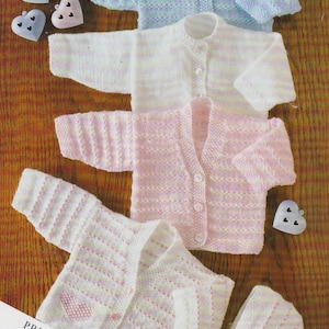 May include: Four knitted baby cardigans in pink, white, and blue with a matching pink and white knitted hat. The cardigans have a striped pattern and button closures. The image includes the text "PREMATURE SIZE INCLUDED".