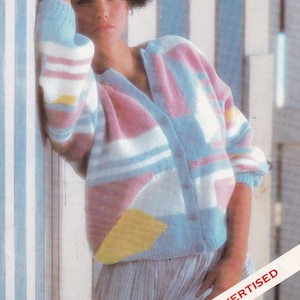 May include: A pastel pink, blue, white and yellow striped cardigan with a geometric pattern. The cardigan has a V-neck and button closure.