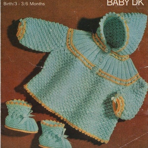 May include: A knitted baby outfit in blue and yellow. The outfit includes a hooded sweater, a pair of booties, and a button closure. The sweater has a ruffled collar and a yellow trim. The booties have a yellow trim and a bow.