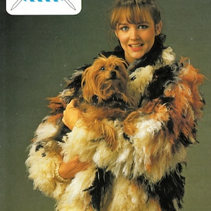 May include: A woman wearing a multi-colored fluffy knit jacket holds a small brown and black dog. The jacket is made with a double knitting technique. The text "DOUBLE KNITTING QUALITIES" is at the top of the image. The text "Lister-Lee" is in the top left corner of the image.