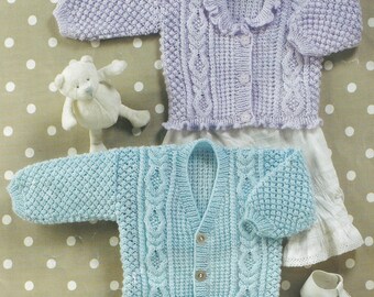 May include: Two knitted baby cardigans, one in light blue and one in lavender, with a cable knit pattern and button closures.