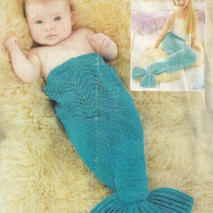 May include: A teal knitted mermaid tail blanket for a baby. The blanket is made with a lacy stitch and has a large tail fin.