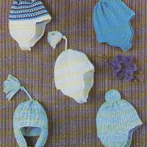 May include: Five knitted baby hats in blue and white colors. The hats have different styles and designs, including a hat with a pom-pom and a hat with a scarf.