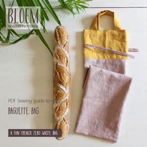 May include: A fresh baguette next to a yellow and pink fabric baguette bag. The bag has a handle and a strap. The text on the image says "BLOEM SEWING PATTERNS" and "PDF Sewing guide to make a BAGUETTE BAG".