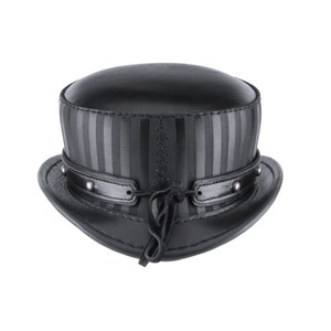 May include: A black leather top hat with a striped band and a leather strap with a tassel.