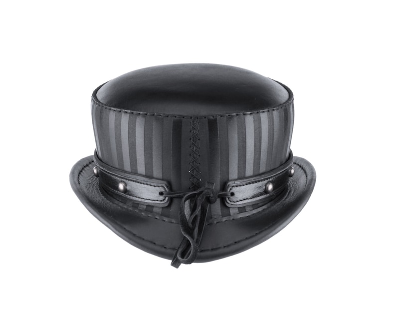 May include: A black leather top hat with a striped band and a leather strap with a tassel.