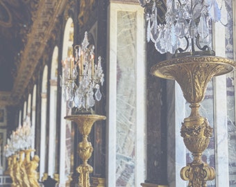 May include: A row of ornate gold candelabras with crystal prisms and candles in a grand hall with marble walls and a gold-leaf ceiling.