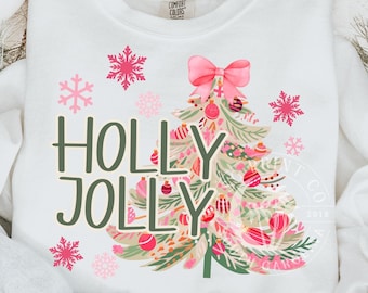 May include: White sweatshirt with a pink and green Christmas tree design and the text "HOLLY JOLLY".
