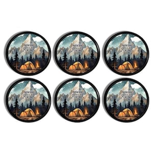 May include: A set of six circular coasters with black rims, each featuring a graphic illustration of a snow-capped mountain range, a forest of pine trees, and a glowing campfire with a tent, including the text Mountains Are Calling.