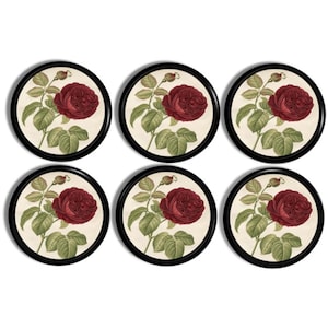 May include: Six round coasters with a black border. Each coaster features a vintage illustration of a red rose with green leaves on a cream background. The coasters are arranged in two rows of three.