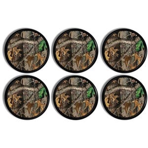 May include: Six round coasters with a camouflage pattern featuring brown, green, and tan colors. Each coaster has a black border. The coasters are arranged in two rows of three.