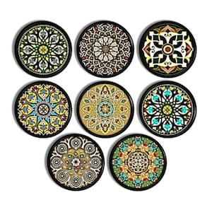 May include: A set of eight circular coasters, each featuring a distinct, intricate geometric pattern with a black border. The designs incorporate a variety of colors including shades of green, blue, yellow, brown, and white in symmetrical arrangements.