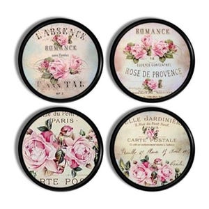 May include: A set of four circular coasters with black borders. Each coaster displays a vintage design with pink roses and French text. The coasters have a distressed, antique appearance, suitable for adding elegance to any room.
