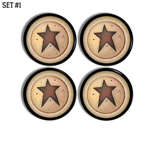 May include: A set of four circular buttons labelled SET #1. Each button features a dark brown five-pointed star centred on a cream-coloured background with a thin brown circular border and a thick black outer rim, accented by small dark speckles.