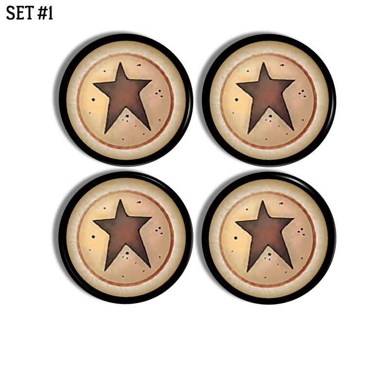 May include: A set of four circular buttons labelled SET #1. Each button features a dark brown five-pointed star centred on a cream-coloured background with a thin brown circular border and a thick black outer rim, accented by small dark speckles.