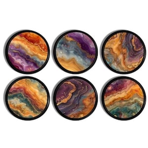 May include: Set of six round coasters with abstract art designs. Each coaster features a swirling pattern of purple, orange, gold, and teal colours. The coasters have a black frame.