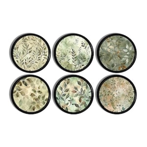 May include: Six circular wall art prints with black frames. Each print displays a unique botanical design with green, brown, and beige leaves. The artwork has a watercolour effect, creating a natural and calming aesthetic.