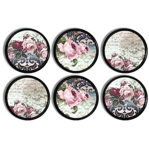 May include: Six round decorative coasters with black edges. Each coaster features a floral design with pink and burgundy roses, set against a vintage-style background with ornate patterns and script.