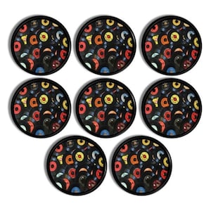 May include: A set of seven circular coasters with a black edge. Each coaster displays a collage of colourful vinyl records. The records are in various colours, including red, yellow, blue, and orange, creating a retro aesthetic.