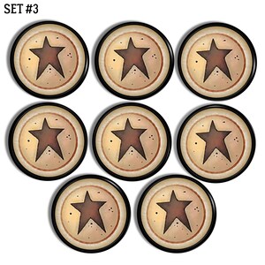 May include: A set of eight circular buttons labelled SET #3. Each button features a dark brown five-pointed star centred on a cream-coloured background with a thin brown ring border and small dark speckles surrounding the star design.