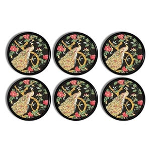 May include: A set of six circular coasters with a black background. Each coaster features a detailed illustration of a peacock with gold and brown plumage perched on a branch, surrounded by red flowers and green leaves, all enclosed in a black rim.