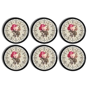 May include: Six round decorative coasters with a vintage floral design. Each coaster features a cream-colored background with Roman numerals and a bouquet of pink and white roses. The coasters have a black border.