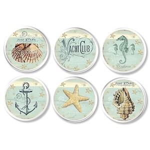 May include: Six round coasters with a nautical theme. Each coaster features a different design, including a seashell, an anchor, a starfish, a seahorse, and the text "Post Card" and "Yacht Club".