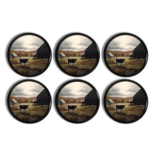May include: A set of six circular coasters with a black edge. Each coaster displays a rural scene with a black cow, a barn, and autumnal trees. These coasters are designed to protect surfaces from drink marks.