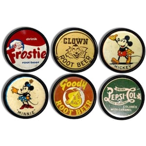 May include: Six vintage round metal signs with black rims. The signs feature retro graphics and text for brands like Frostie Root Beer, Clown Root Beer, Mickey Mouse, Minnie Mouse, Goody Root Beer, and Pepsi-Cola.
