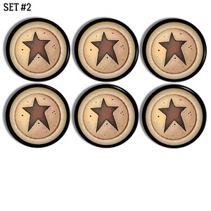 May include: A set of six circular buttons, labelled SET #2, each featuring a dark brown five-pointed star centred on a cream-coloured background with small black speckles, enclosed by a thin reddish-brown ring and a solid black outer border.