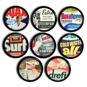 May include: Nine circular wall art pieces with vintage advertising designs. The pieces feature brands such as Ajax, Surf, and Dreft. Each design is in a different color scheme, and each is framed in black.