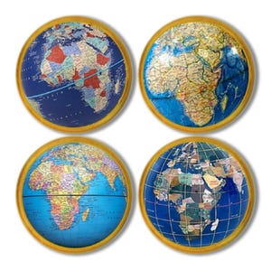 May include: Four round decorative items featuring detailed maps of the African continent. Each map is set within a gold-colored circular frame. The maps display various colors, including blue, green, red, and yellow, representing different geographical regions.