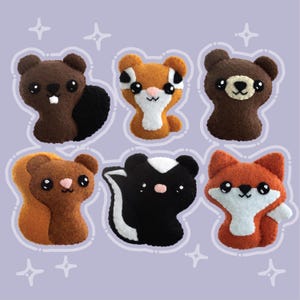 May include: Six plush animal toys with cute faces. The animals are a beaver, squirrel, bear, skunk, fox, and a raccoon. The toys are all brown, black, and orange.