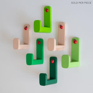 Wooden kids ladybug wall hooks, various green colors