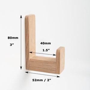 May include: Wooden wall hook in the shape of an L. The hook is 3 inches tall, 1.5 inches wide, and 2 inches deep.