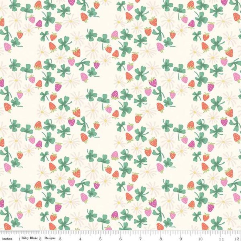 May include: A white fabric with a repeating pattern of green four-leaf clovers, pink and orange strawberries, and white flowers.