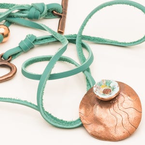 Copper Disc Pendant with Raised Enamel Flower on Turquoise Leather Cord