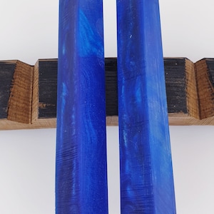 May include: Two blue resin blanks for crafting, with a marbled pattern and a textured surface.
