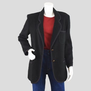 May include: A handmade, wooden cutting board with a natural finish. The board features a live edge on one side and a smooth, rectangular shape. It measures approximately 18 inches long and 12 inches wide.