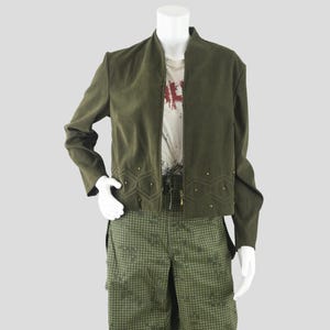 May include: A white ceramic mug with a black handle and the text "But First, Coffee" in a black, bold font. The mug is sitting on a wooden surface. The mug is 4 inches tall.