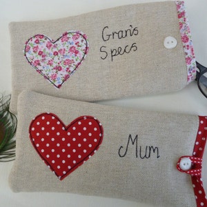 Personalised heart applique glasses case.  Spectacles or sunglasses pouch with choice of red dot or pink floral heart on linen or grey wool. coordinating ribbon and button fastening.  unique handmade customisable anniversary valentines gift