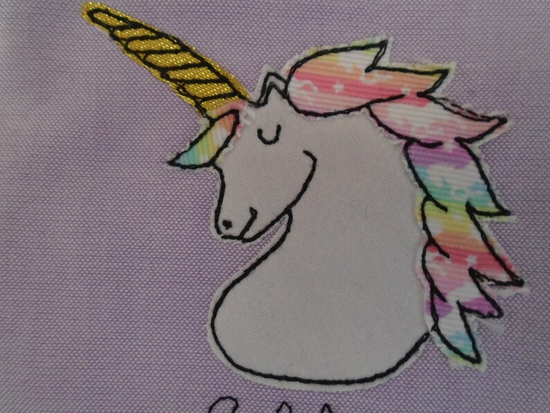 Unicorn motif personalised pencil case or cosmetic bag.  Pen or makeup pouch with choice of colour and coordinating lining.  Fastened with a zip and rainbow ribbon pull.  Ideal girls back to school gift