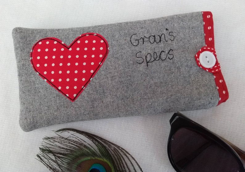 Personalised heart applique glasses case.  Spectacles or sunglasses pouch with choice of red dot or pink floral heart on linen or grey wool. coordinating ribbon and button fastening.  unique handmade customisable anniversary valentines gift