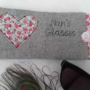 Personalised heart applique glasses case.  Spectacles or sunglasses pouch with choice of red dot or pink floral heart on linen or grey wool. coordinating ribbon and button fastening.  unique handmade customisable anniversary valentines gift
